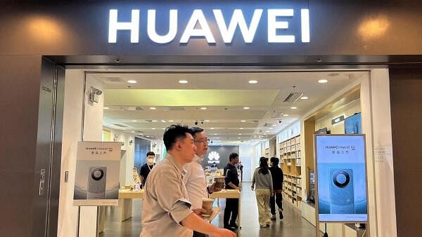 <div class="paragraphs"><p>People walk past a Huawei store with advertisements for the Mate 60 series smartphones, at a shopping mall in Beijing, China.</p></div>