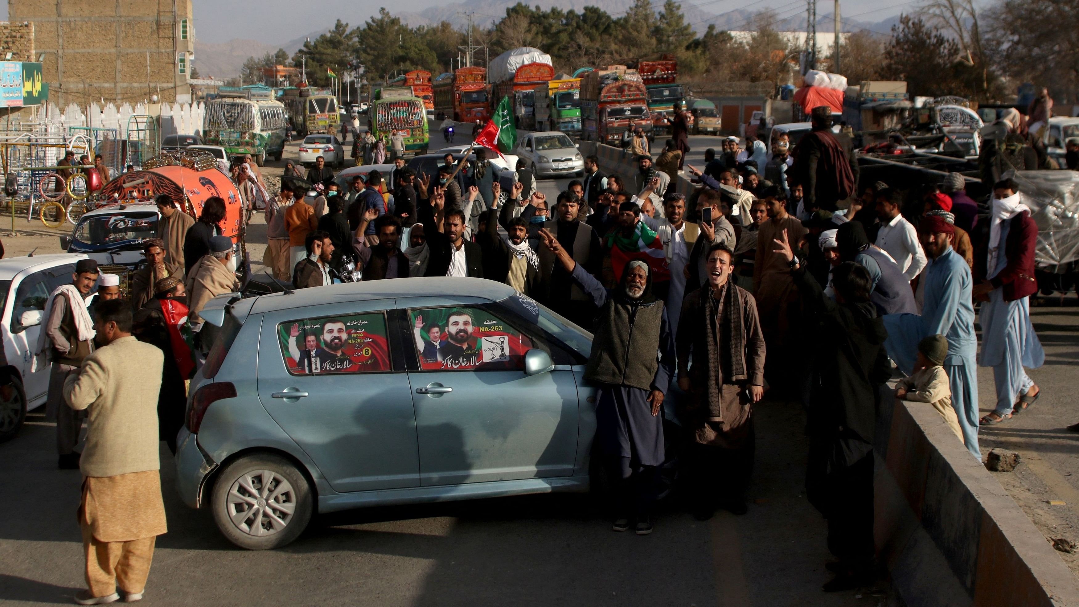 <div class="paragraphs"><p>Supporters of Pakistani former Prime Minister Imran Khan's party, the Pakistan Tehreek-e-Insaf, block a road to protest against the results of the general election.</p></div>