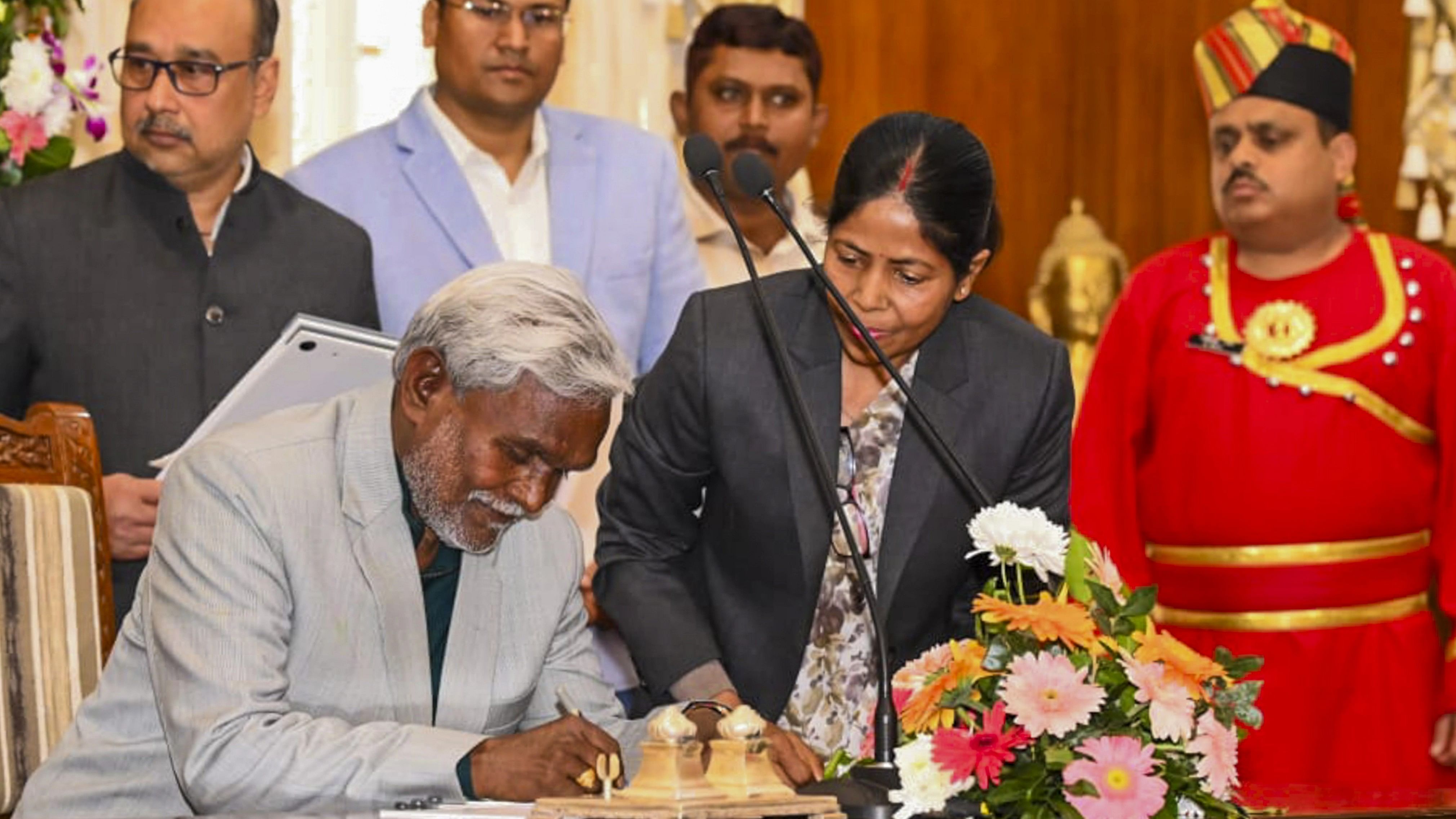 <div class="paragraphs"><p>JMM leader Champai Soren signs documents after taking oath as Jharkhand CM during the swearing-in ceremony, at Raj Bhawan in Ranchi on Friday.</p></div>