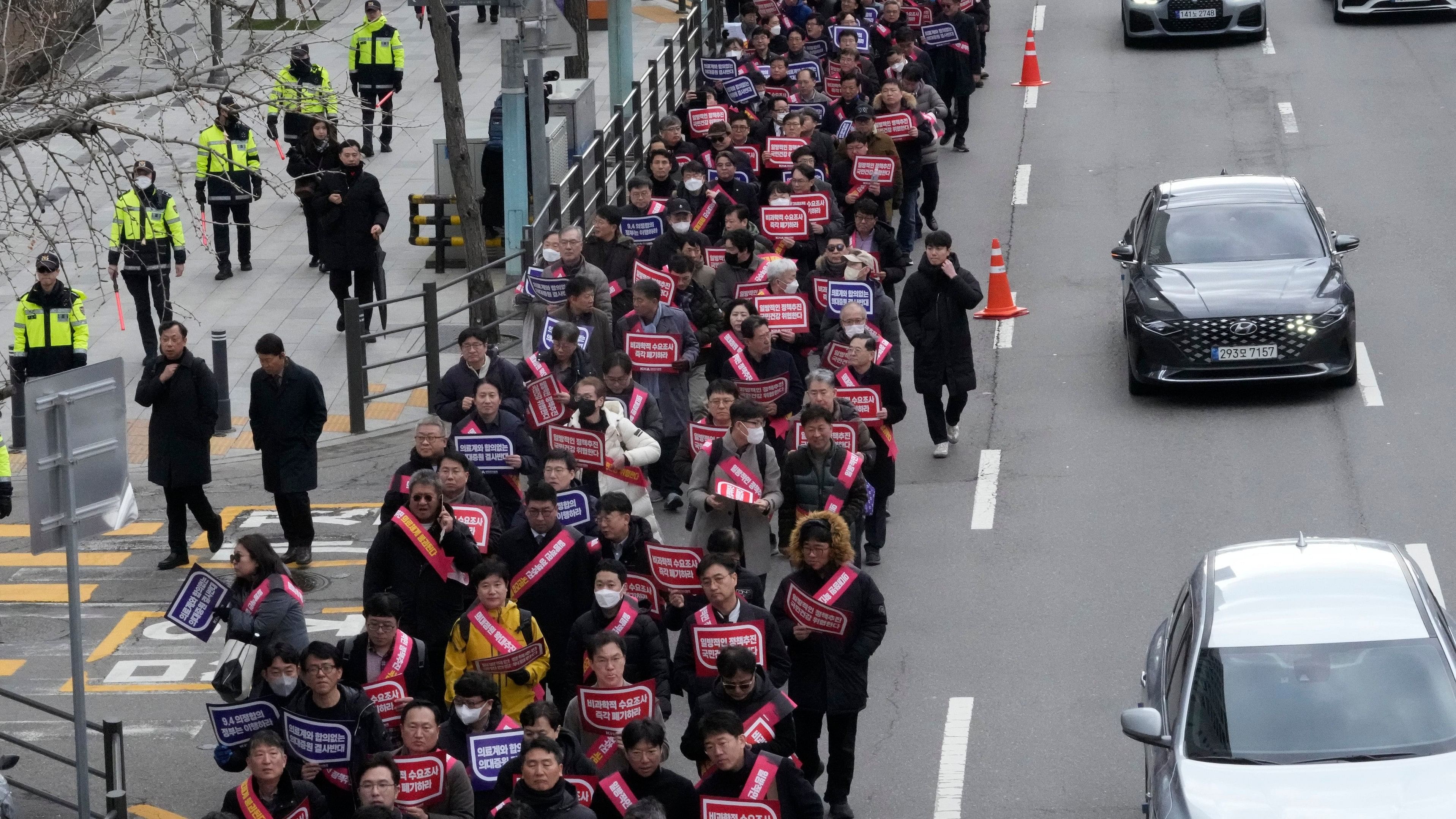 <div class="paragraphs"><p>A photo of doctors marching towards the presidential office during a rally against the government's medical policy in Seoul, South Korea, </p></div>