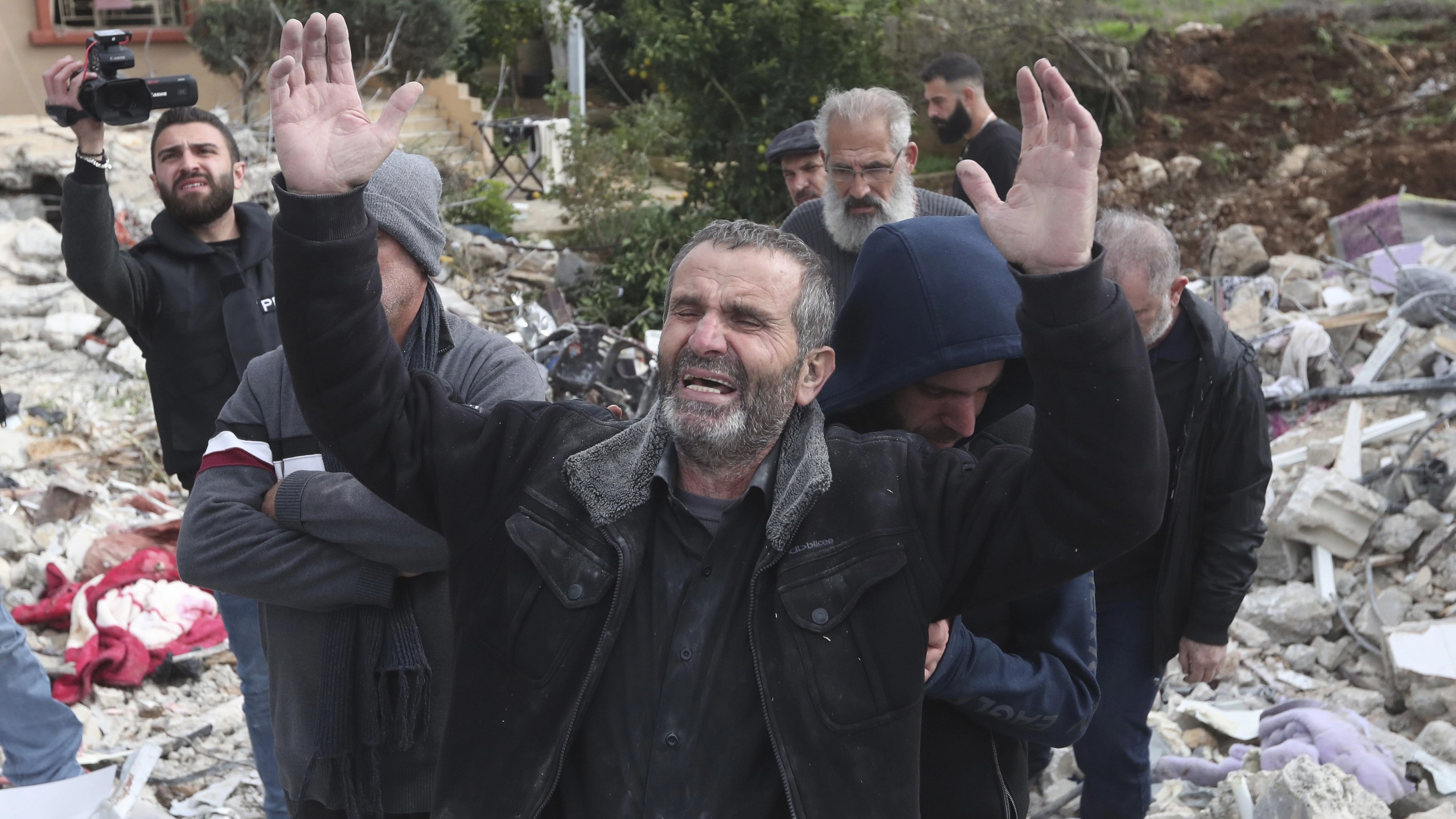 <div class="paragraphs"><p>A civilian reacts next to his house, destroyed by an Israeli airstrike in South Lebanon.</p></div>