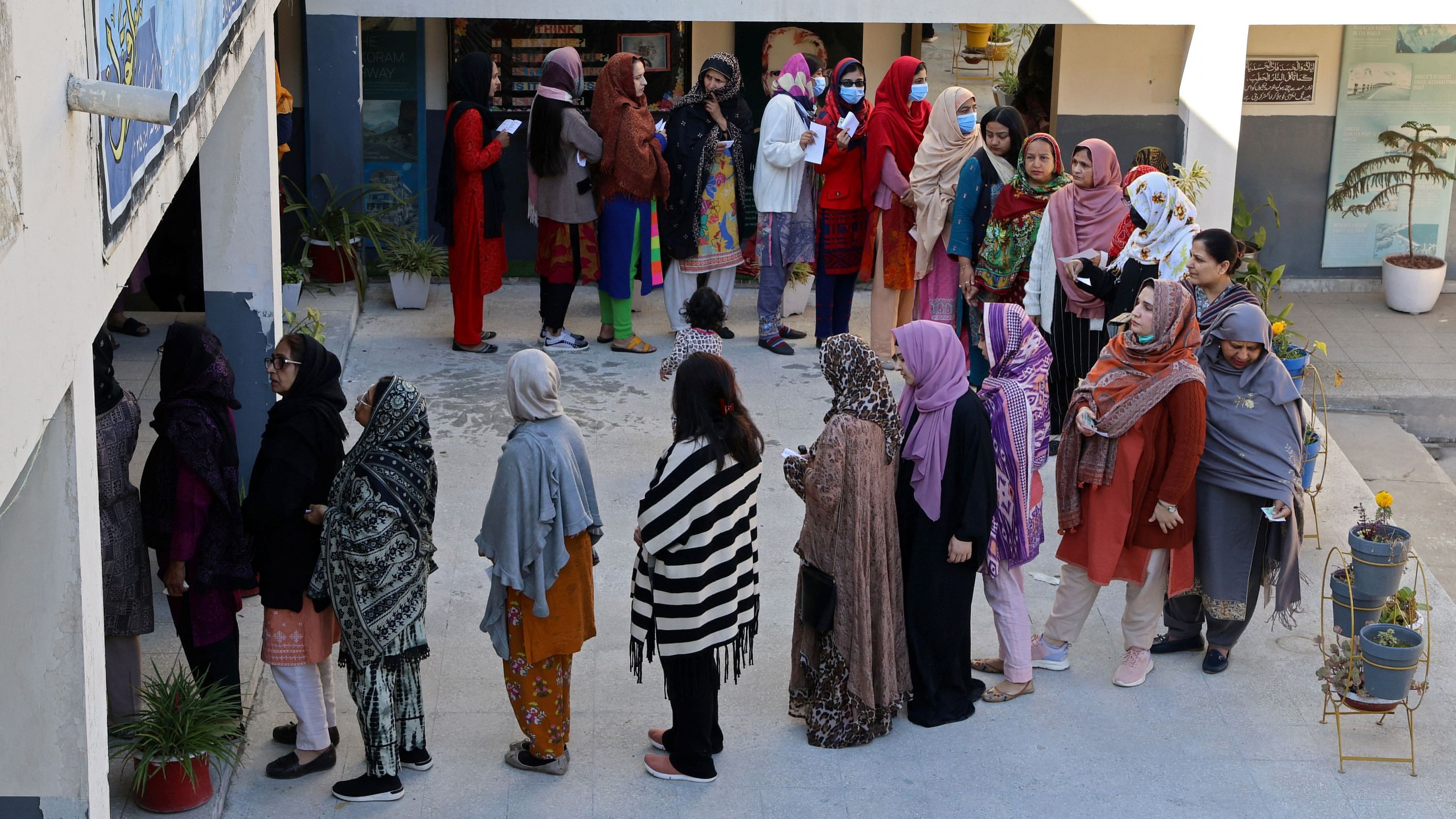 <div class="paragraphs"><p>Voters queue to vote at a polling station in a school during a general election, in Islamabad, Pakistan February 8, 2024.</p></div>