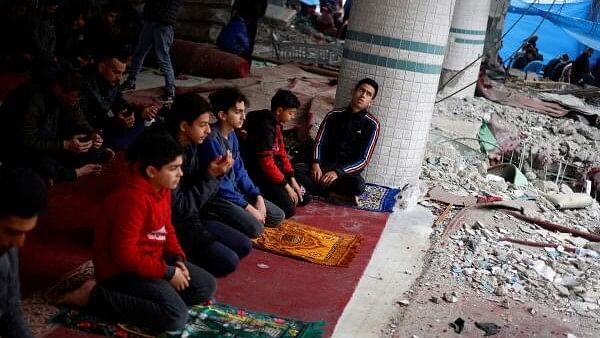 <div class="paragraphs"><p>Palestinians perform Friday prayers at the ruins of a mosque destroyed in Israeli strikes, amid the ongoing conflict between Israel and Hamas, in Rafah in the southern Gaza Strip.</p></div>