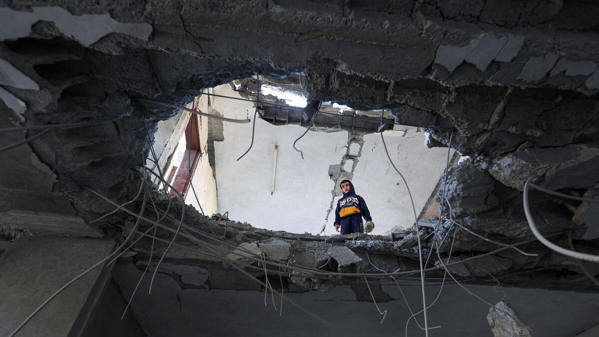 <div class="paragraphs"><p>A Palestinian child looks on inside a damaged building at the site of an Israeli strike amid the ongoing conflict between Israel and Palestinian Islamist group Hamas, in Rafah in the southern Gaza Strip February 3, 2024</p></div>