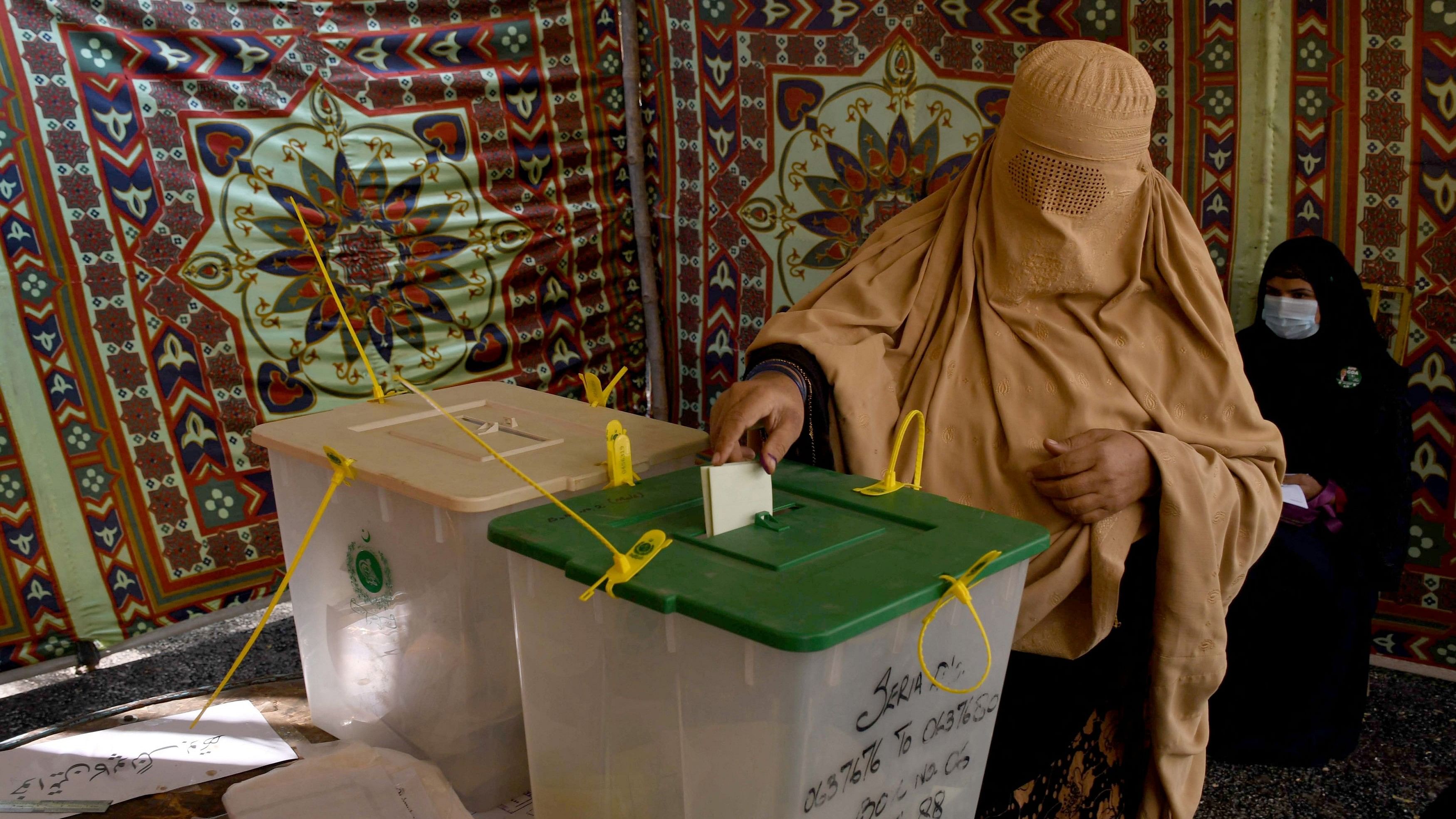 <div class="paragraphs"><p>A burqa-clad woman casts her vote at a polling station during a general election, in Tando Allahyar, Sindh, Pakistan, February 8, 2024.</p></div>