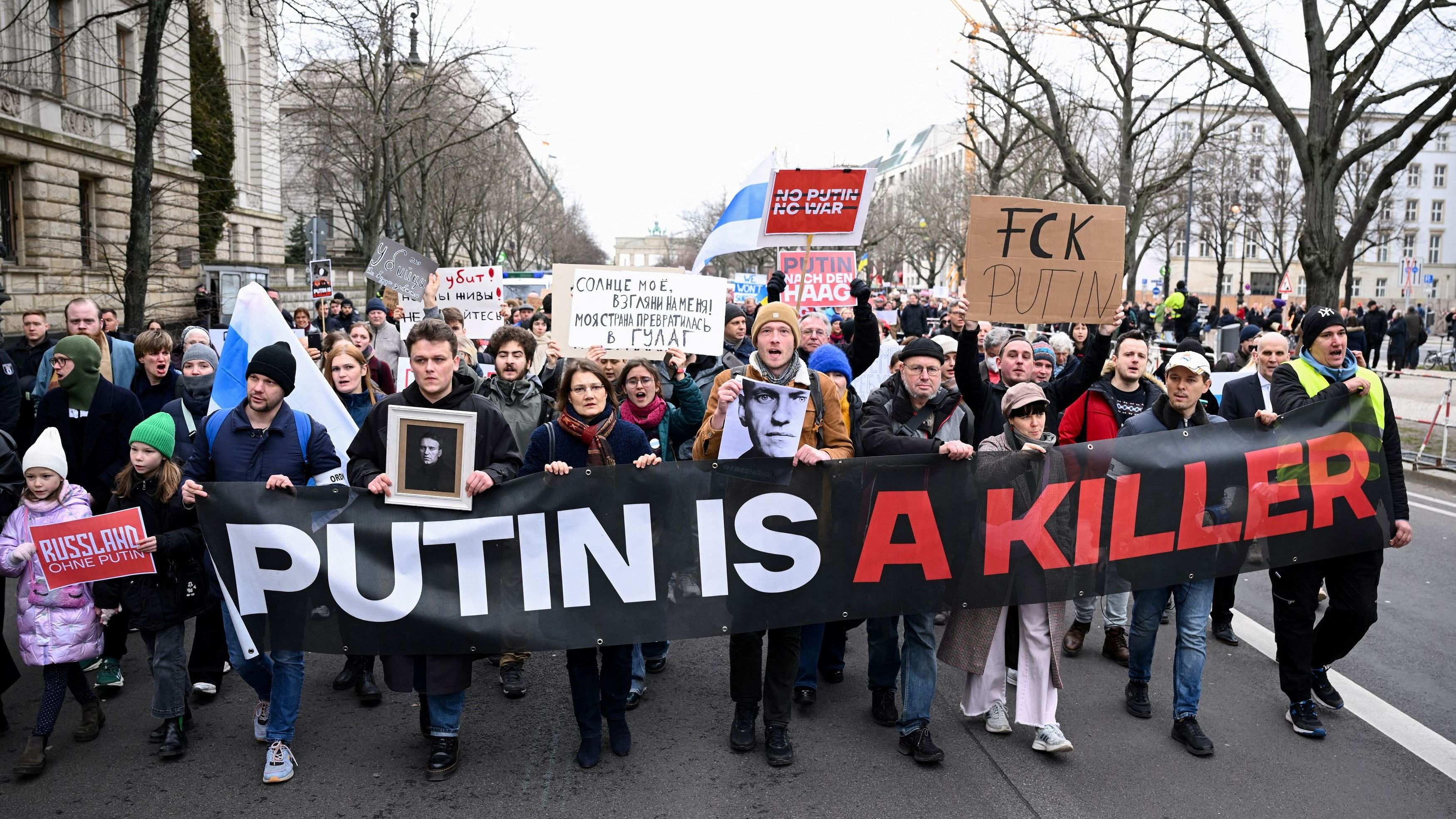 <div class="paragraphs"><p>People hold a banner as they attend a rally held near the Russian embassy following the death of Russian opposition leader Alexei Navalny, in Berlin, Germany, February 18, 2024. </p></div>