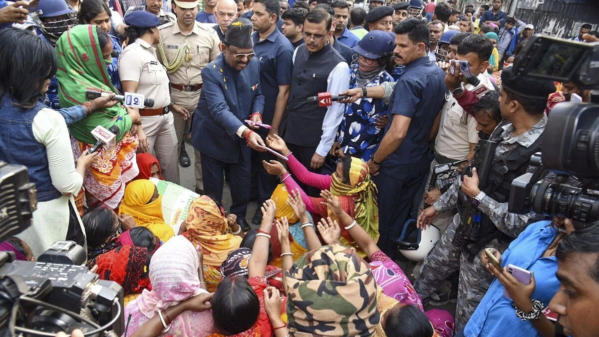 <div class="paragraphs"><p>West Bengal Governor CV Ananda Bose with women protestors and others at Sandeshkhali block, in North 24 Parganas district, Monday, Feb. 12, 2024.</p></div>