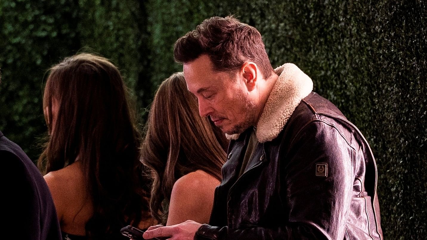 <div class="paragraphs"><p>Elon Musk uses his phone before the premiere of ''Lola'' held at the Regency Bruin Theatre in Los Angeles, California, U.S.,  February 3, 2024. </p></div>
