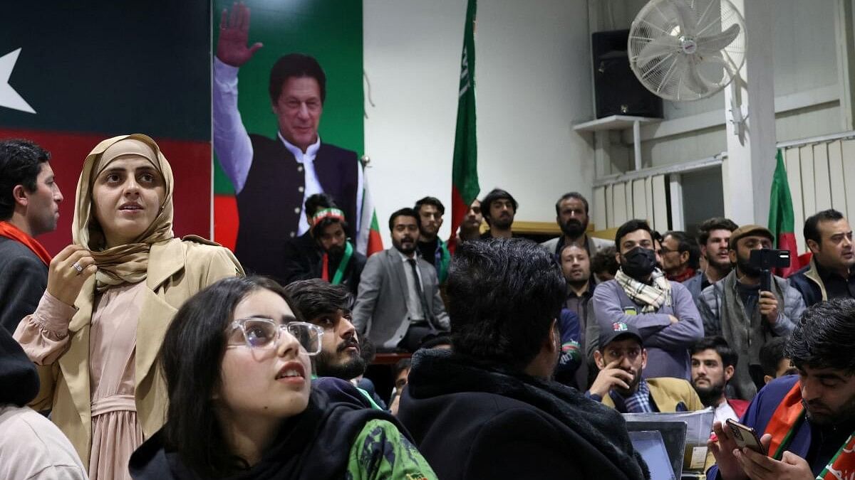 <div class="paragraphs"><p>Volunteers for former Prime Minister Imran Khan's party Pakistan Tehreek-e-Insaf (PTI) look on as they watch results on TV screens after the end of the polling during a general election at the party's main office in Islamabad, Pakistan, February 8, 2024. </p></div>