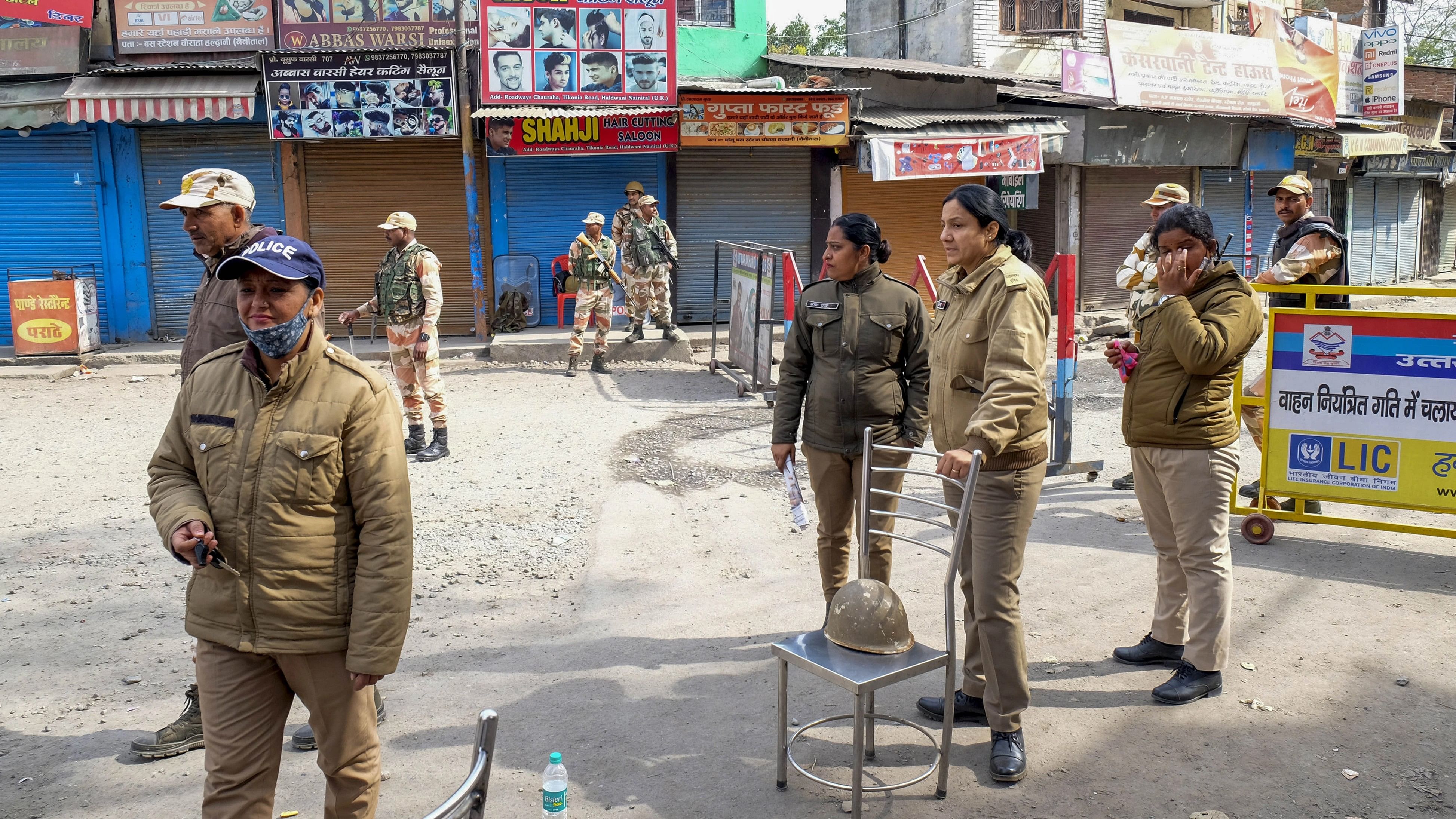 <div class="paragraphs"><p>Haldwani: Indo-Tibetan Border Police (ITBP) and Uttarakhand Police personnel stand guard on a road during a curfew at Banbhoolpura area, following incidents of violence after the demolition of an 'illegally built' madrasa, in Haldwani.</p></div>