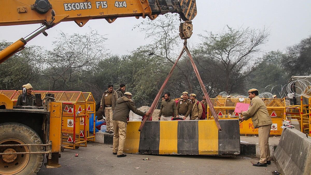 <div class="paragraphs"><p>Police barricades being placed on Delhi-Gurugram Expressway in view of farmers' protest march.</p></div>