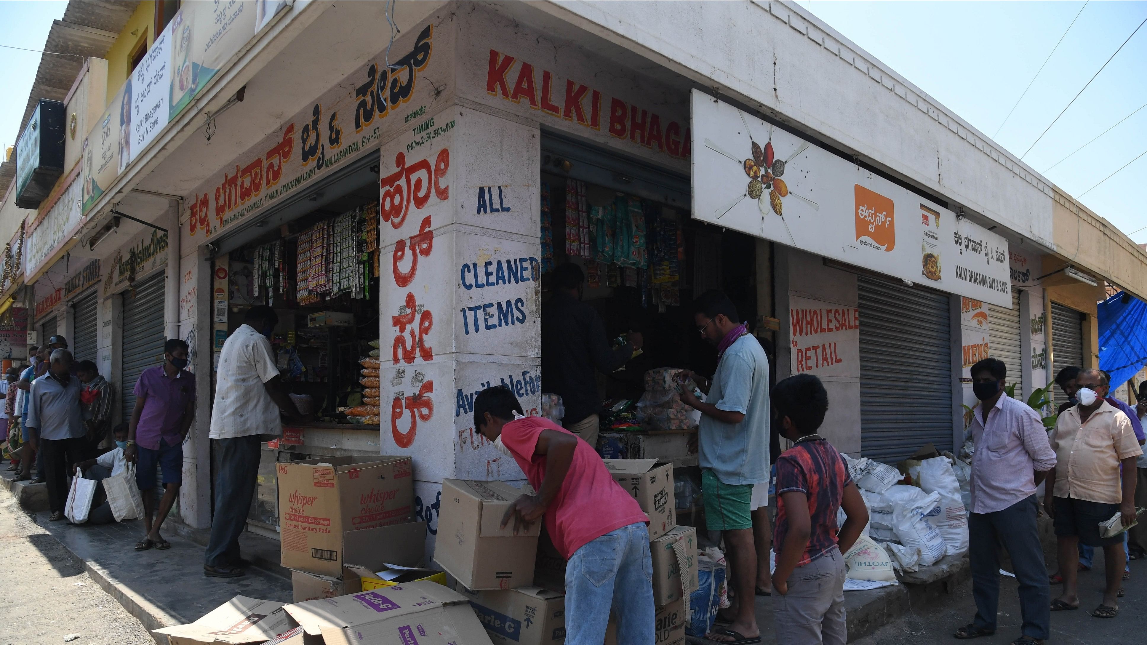 <div class="paragraphs"><p>People line up for groceries at a store, at Bagalgunte, in Bengaluru on Monday. </p></div>