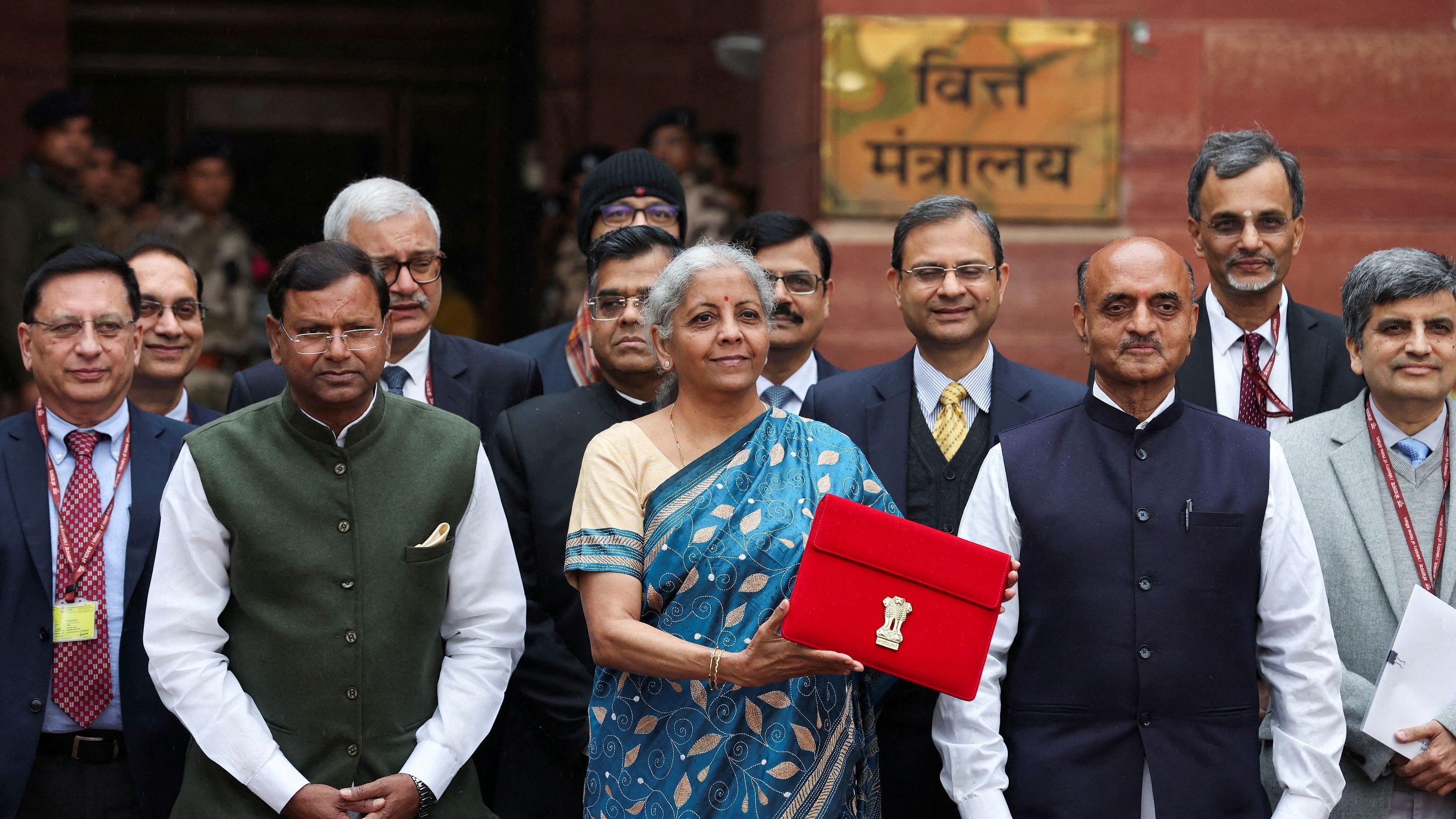 <div class="paragraphs"><p> India's Finance Minister Nirmala Sitharaman holds up a folder with the Government of India's logo as she leaves her office to present the federal budget in the parliament,</p></div>