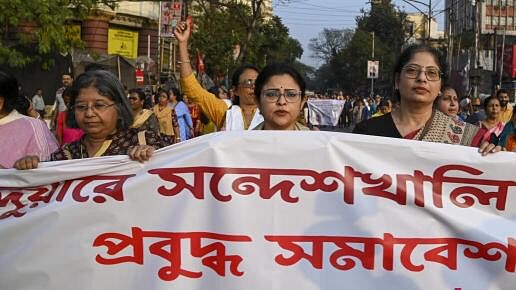 <div class="paragraphs"><p>People hold a banner during a protest march against Sandeshkhali case, in Kolkata.</p></div>