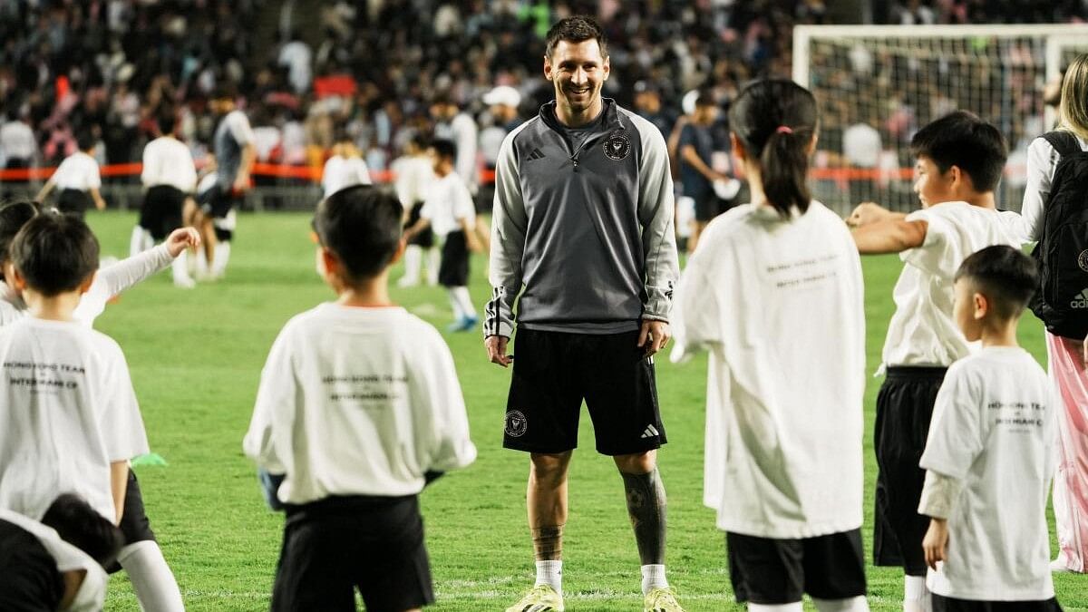 <div class="paragraphs"><p>Lionel Messi plays football with children during training at the Hong Kong Stadium.</p></div>