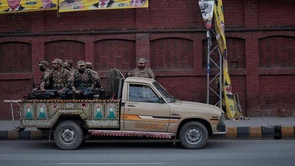 <div class="paragraphs"><p>Army personnel sit in a vehicle near a polling station on the day of the general election, in Lahore, Pakistan February 8, 2024</p></div>