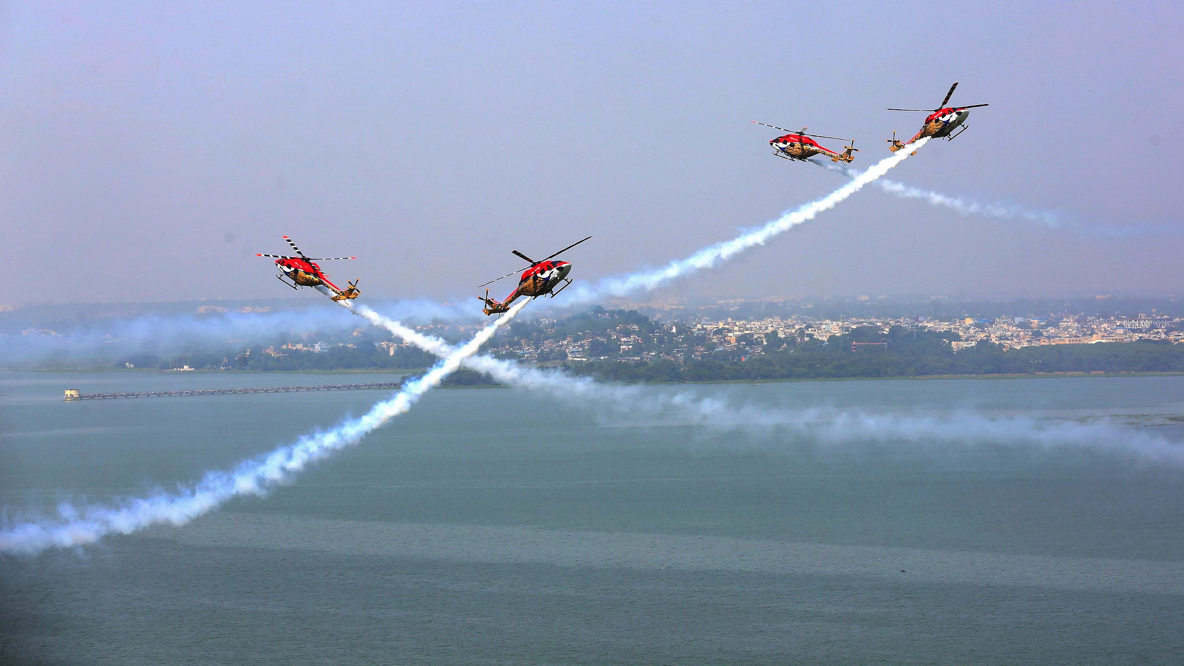 <div class="paragraphs"><p>Helicopters of the Indian Air Force's aerobatic team 'Sarang' perform during an air show.</p></div>