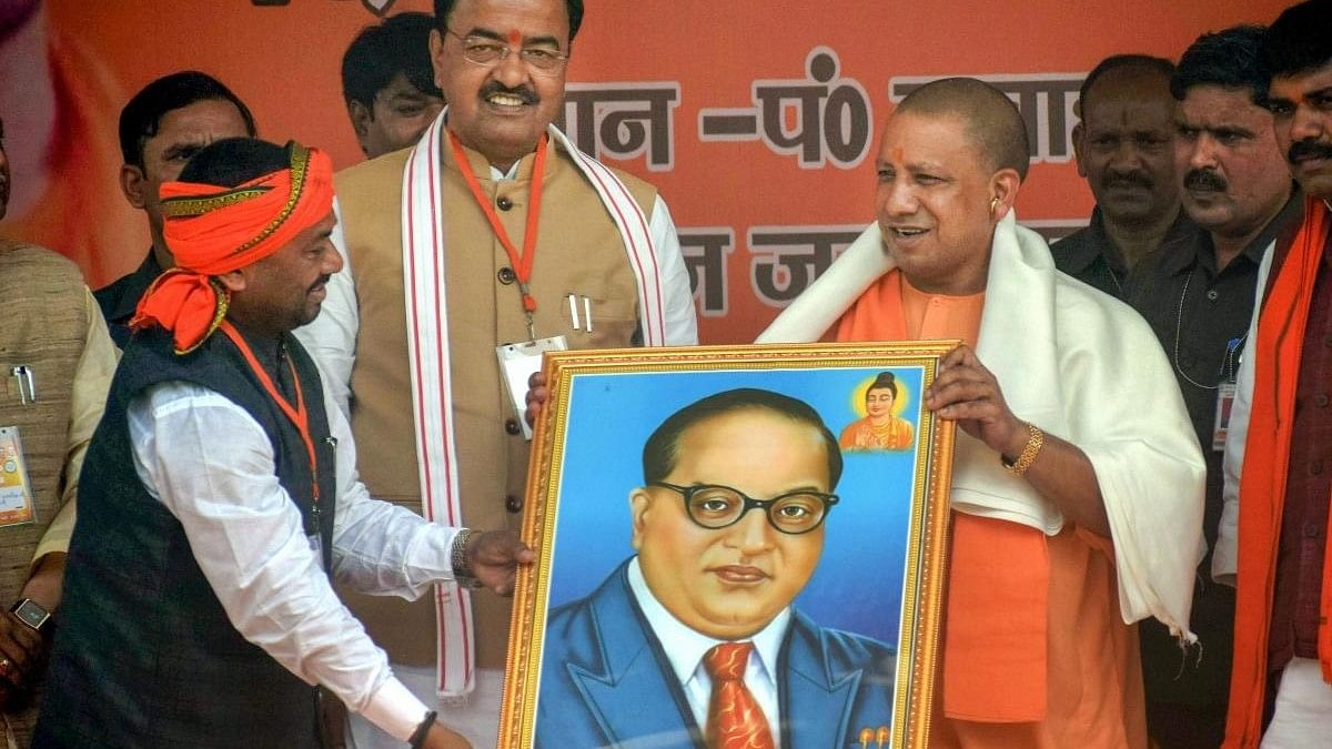 <div class="paragraphs"><p>Uttar Pradesh Chief Minister Yogi Adityanath being presented a portrait of Dr B R Ambedkar.</p></div>