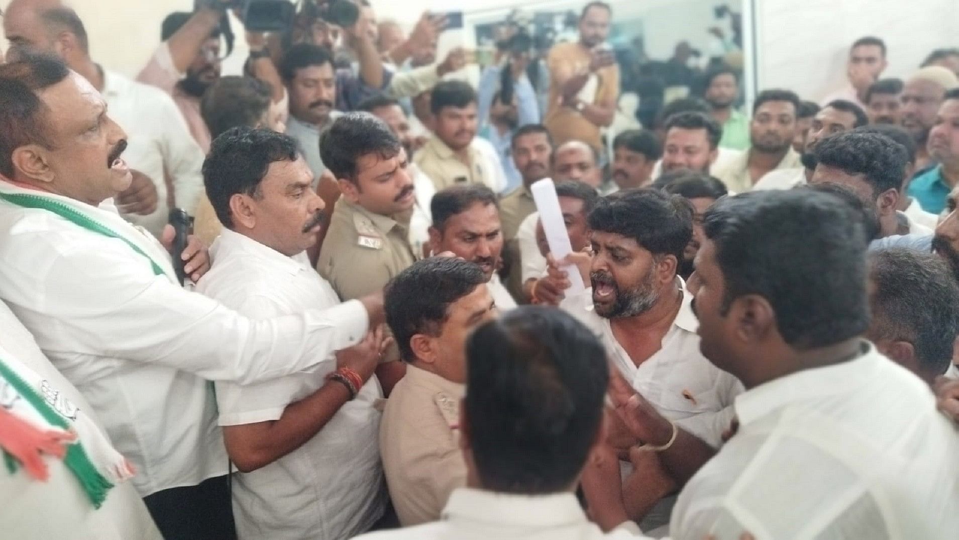 Congress leaders argue as police personnel try to calm tempers down at the district party office in Kolar on Tuesday.