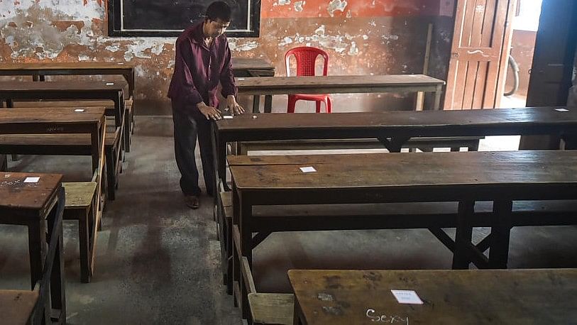 <div class="paragraphs"><p>File photo of a worker pasting roll numbers of students on a bench, as part of preparation for the 'Madhyamik' (West Bengal Board of Secondary Education) examination.&nbsp;</p></div>