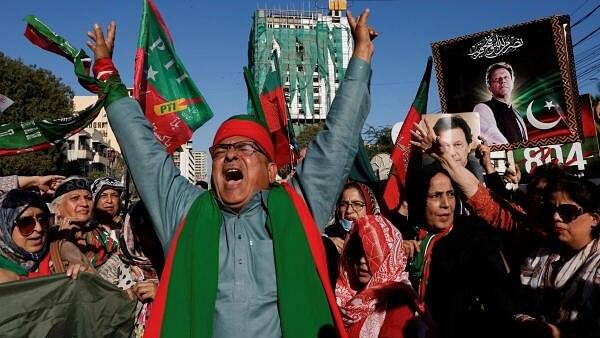 <div class="paragraphs"><p>Supporters of former Prime Minister Imran Khan's party, the Pakistan Tehreek-e-Insaf (PTI), chant slogans as they gather during a protest demanding free and fair results of the elections, outside the provincial election commission office in Karachi, Pakistan February 17, 2024.</p></div>