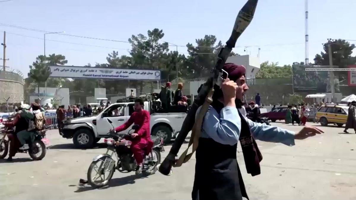 <div class="paragraphs"><p>A Taliban fighter runs towards crowd outside Kabul airport, Kabul, Afghanistan.</p></div>