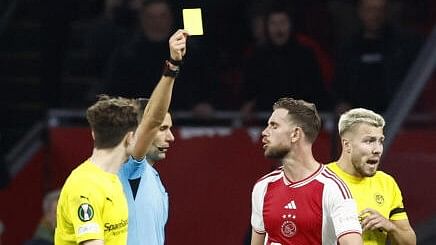 <div class="paragraphs"><p>A football referee giving a yellow card to a player.</p></div>