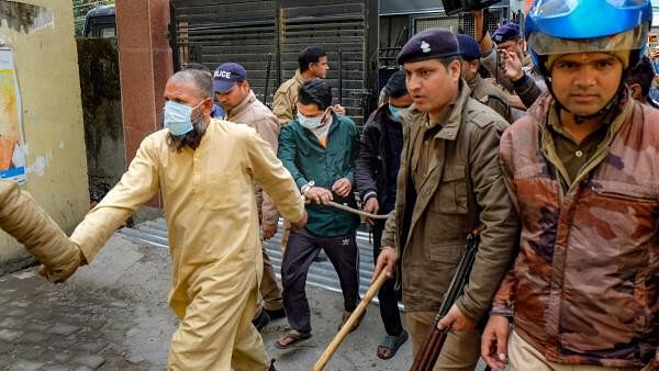 <div class="paragraphs"><p>People arrested on charges of taking part in violence that erupted after the demolition of an 'illegally built' madrasa being taken to a hospital for medical check-up, in Haldwani, Monday, February 12, 2024.</p></div>