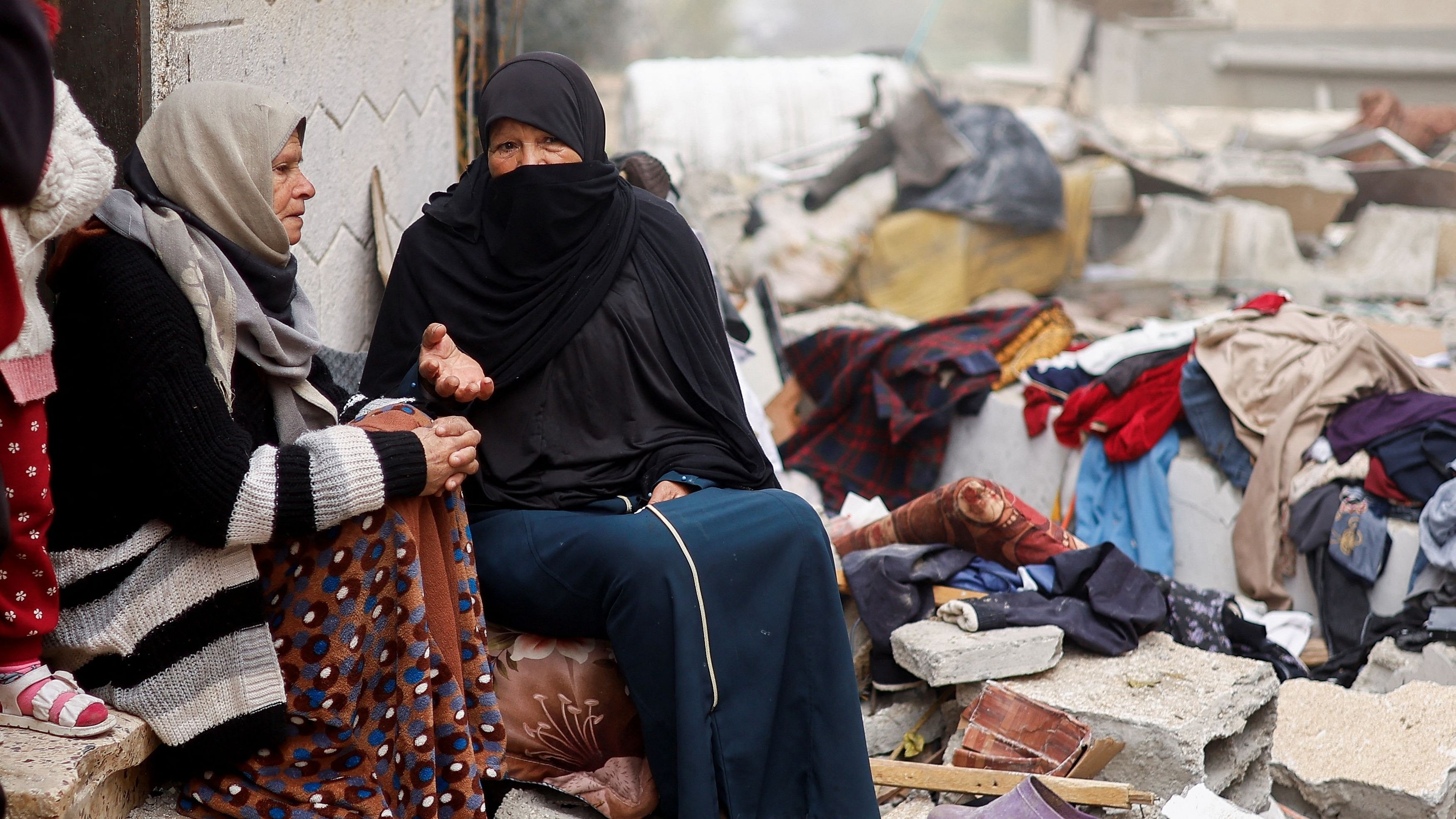 <div class="paragraphs"><p>Palestinian women talk as they sit at the site of an Israeli strike on a house, amid the ongoing conflict between Israel and the Palestinian Islamist group Hamas, in Rafah in the southern Gaza Strip, February 9, 2024. </p></div>