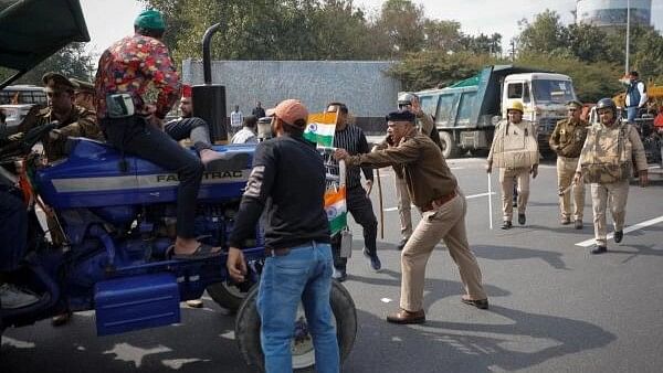 <div class="paragraphs"><p>Police officers try to stop farmers driving a tractor during a protest demanding a hike in land compensation and better rehabilitation facilities for their families, in Noida on the outskirts of New Delhi.</p></div>