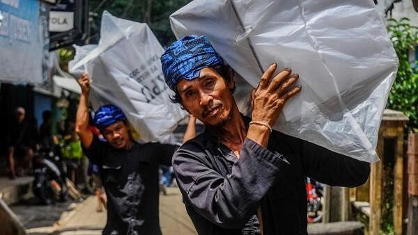 <div class="paragraphs"><p>Baduy men carry ballot boxes during distribution at Kanekes village in Lebak, Banten province, Indonesia.</p></div>