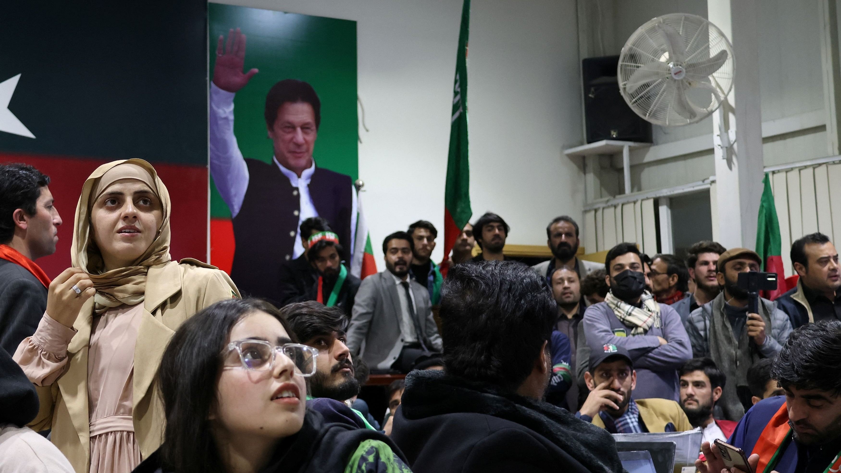 <div class="paragraphs"><p>Volunteers for former Prime Minister Imran Khan's party Pakistan Tehreek-e-Insaf  look on as they watch results on TV screens after the end of the polling during a general election at the party's main office in Islamabad, Pakistan, February 8, 2024. </p></div>