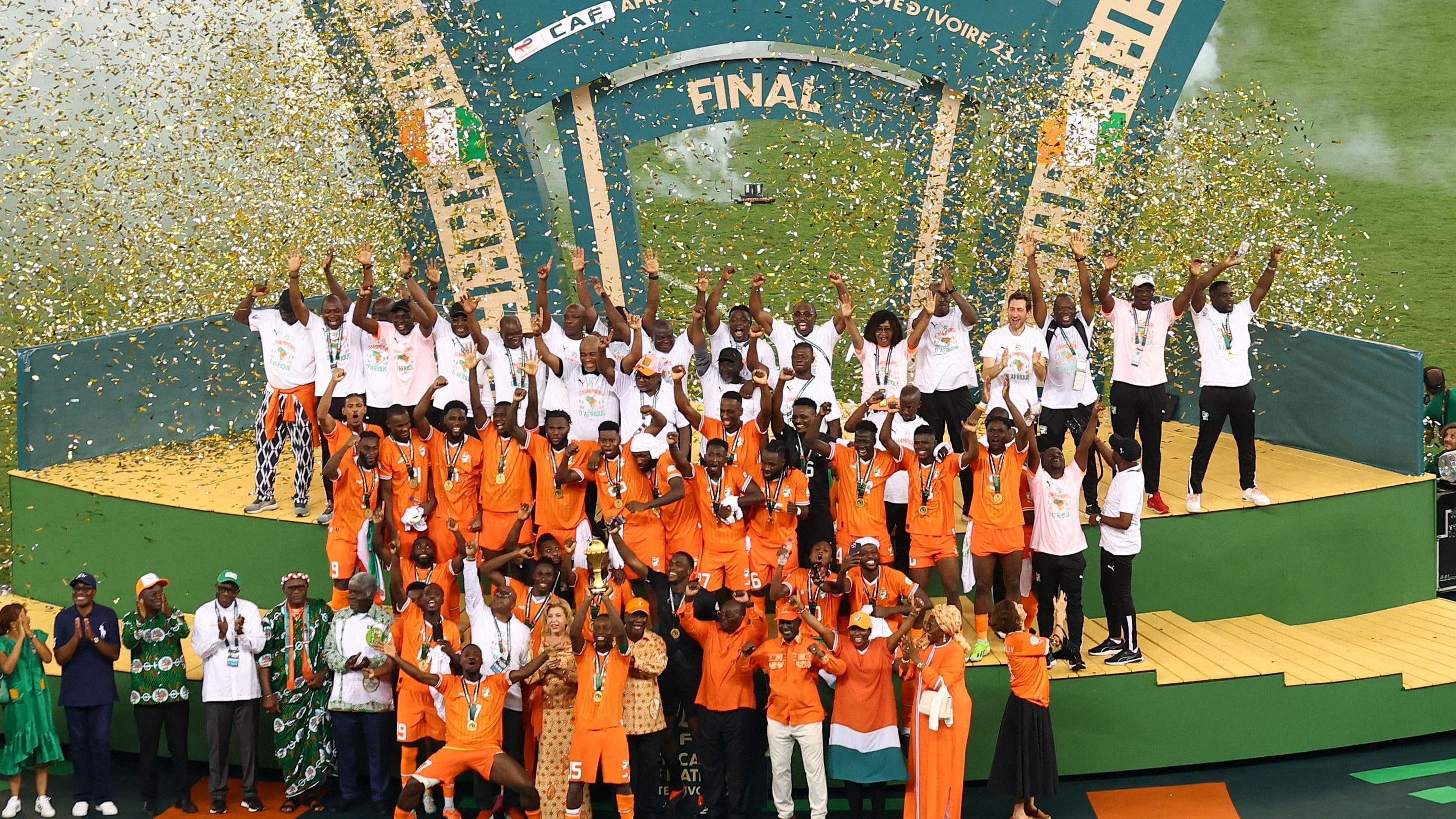 <div class="paragraphs"><p> Ivory Coast's Max Gradel lifts the trophy as he celebrates with teammates after winning the Africa Cup of Nations.</p></div>