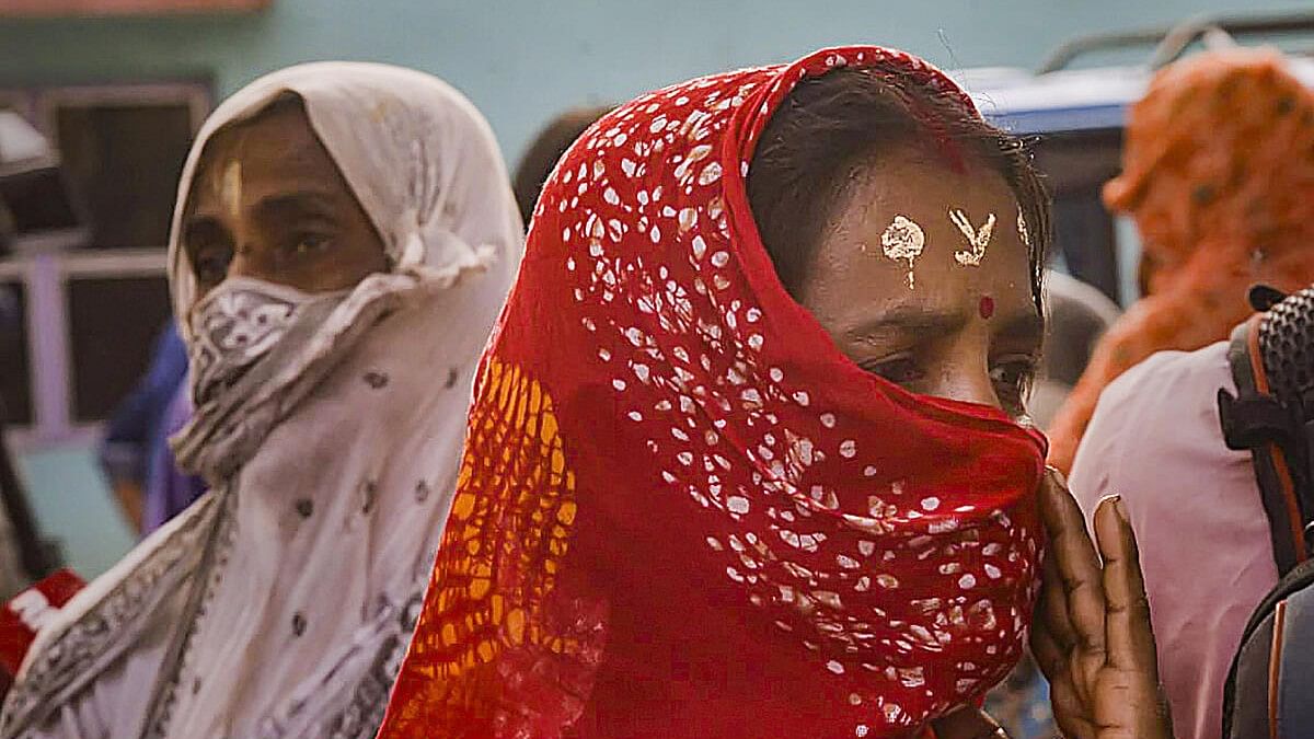 <div class="paragraphs"><p>Local women wait to meet National Commission for Women (NCW) Chairperson Rekha Sharma (not seen) during her visit to Sandeshkhali, in North 24 Parganas district, Monday, Feb. 19, 2024.</p></div>