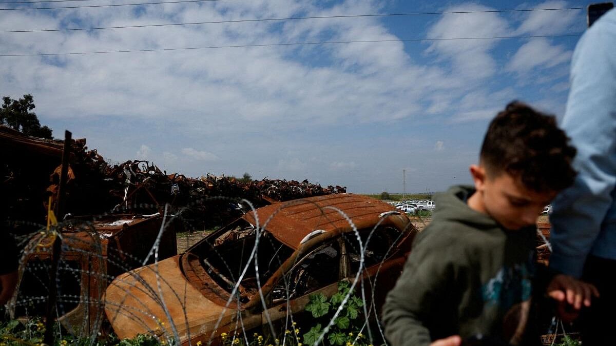 <div class="paragraphs"><p>People visit a site where damaged vehicles from the deadly October 7 attack are piled up, near Netivot.</p></div>