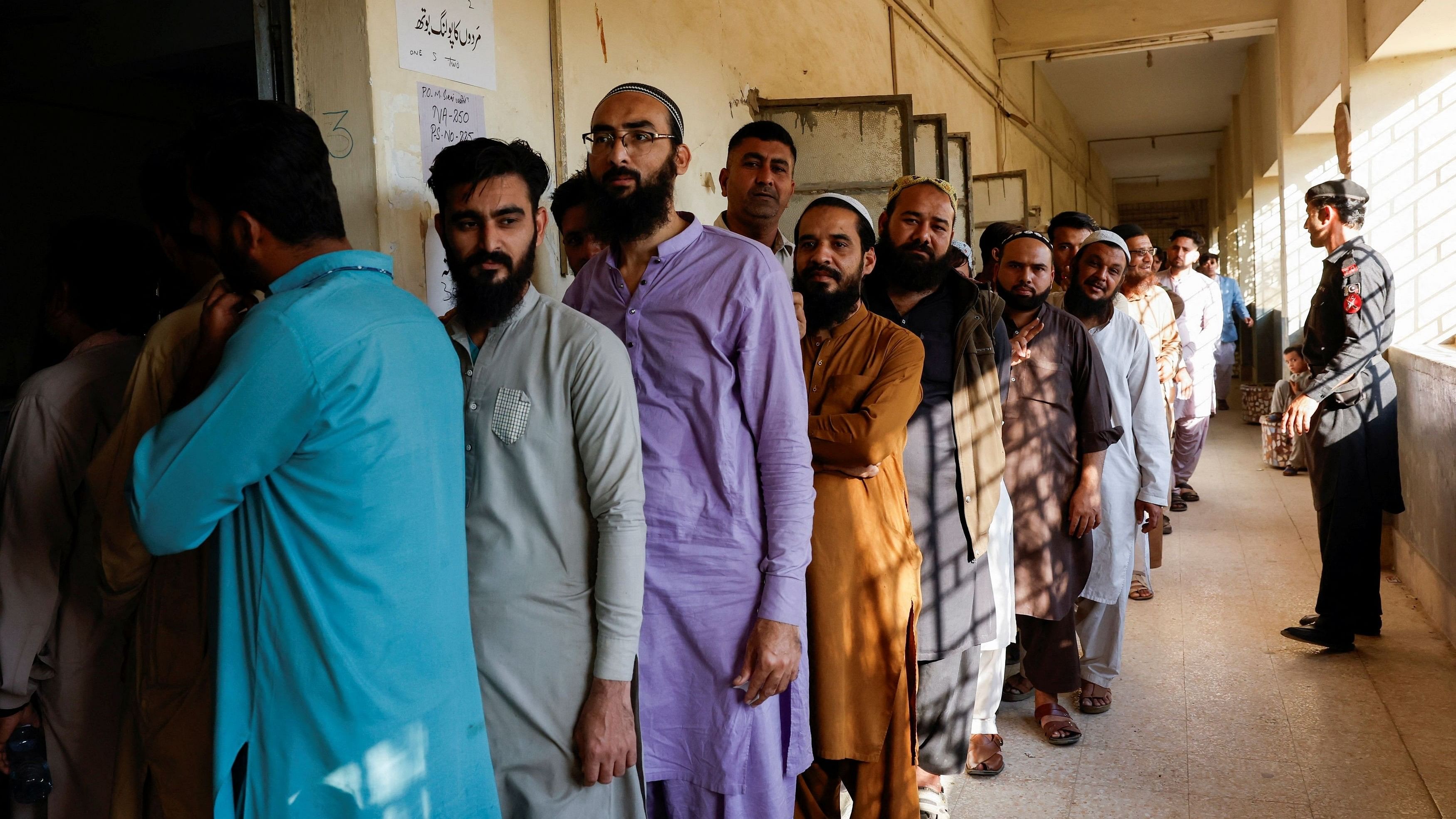 <div class="paragraphs"><p>People wait for their turn to cast a vote at a polling station during the general election in Karachi, Pakistan.</p></div>