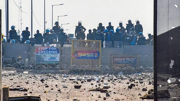 <div class="paragraphs"><p>Security personnel stand guard as brick bats and stones lie on the roads at the Punjab-Haryana Shambhu border during farmers' 'Delhi Chalo' march, near Patiala district, Thursday, February 15, 2024</p></div>