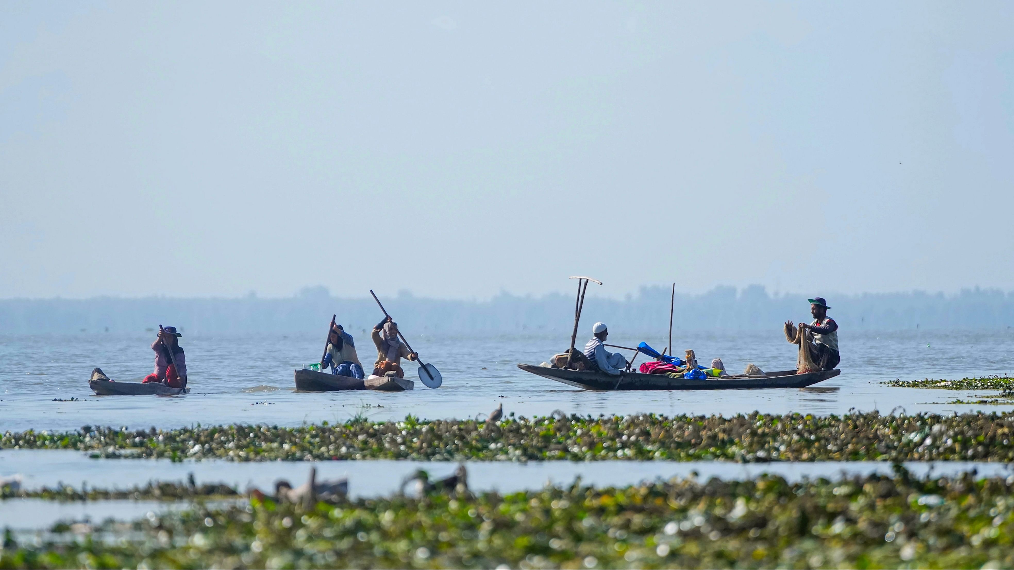 <div class="paragraphs"><p>Fishermen look for a catch in the Wular Lake, in Bandipora district</p></div>