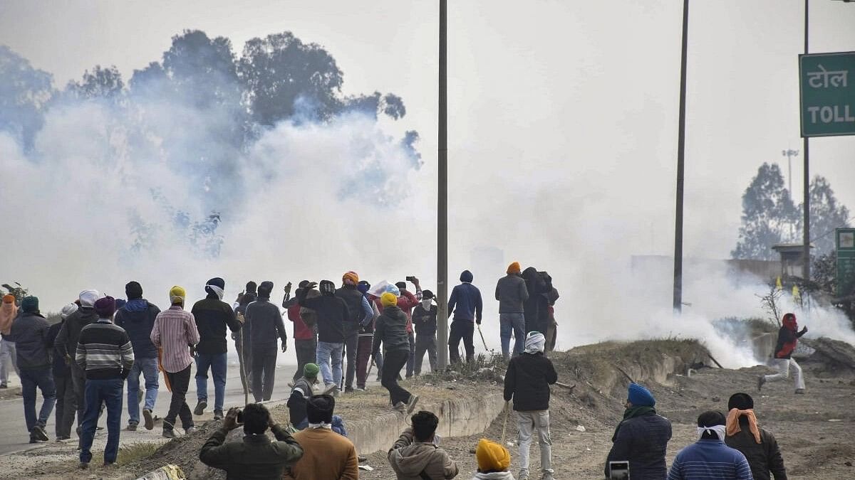 <div class="paragraphs"><p>Farmers move away after police fired teargas shell to disperse them during their 'Delhi Chalo' march at Punjab-Haryana Shambhu border, near Patiala, Tuesday, Feb. 13, 2024.</p></div>