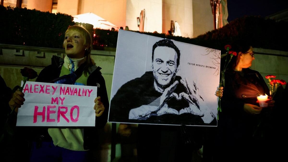 <div class="paragraphs"><p>A person holds a placard that reads: "Alexey Navalny is my hero", as people pay tribute to Russian opposition leader Alexei Navalny, following his death, at the Trocadero near the Eiffel Tower in Paris, France, February 17, 2024. </p></div>