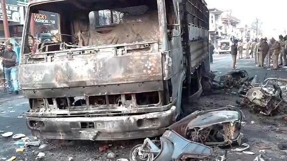 <div class="paragraphs"><p>Charred remains of vehicles lie on a road after local residents on Thursday set vehicles and a police station on fire and hurled stones.</p></div>