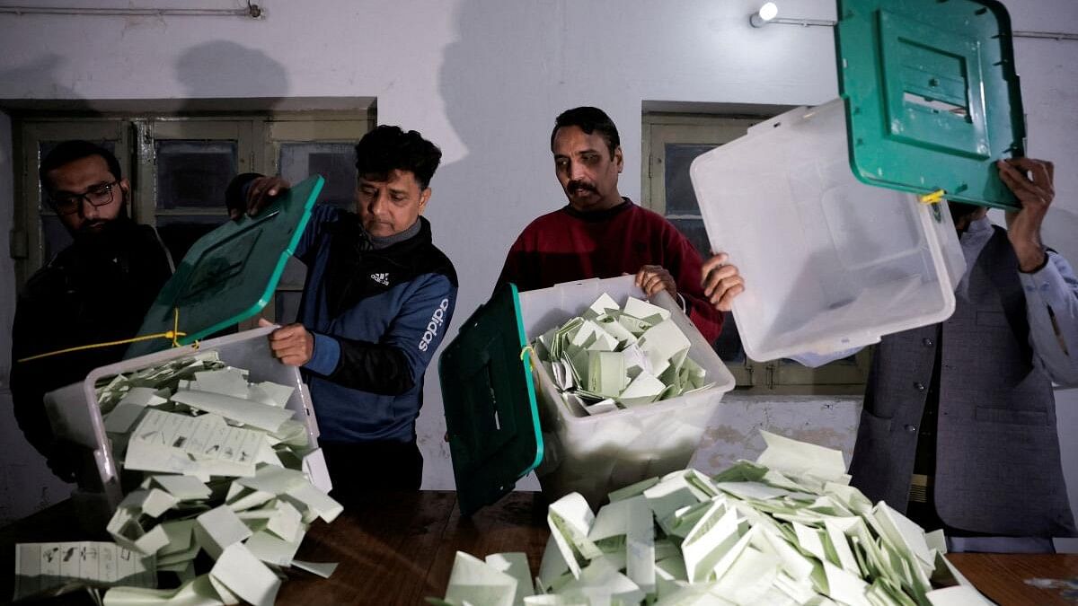 <div class="paragraphs"><p>Polling staff empty a ballot box after polls closed at a polling station during the general election in Pakistan.</p></div>
