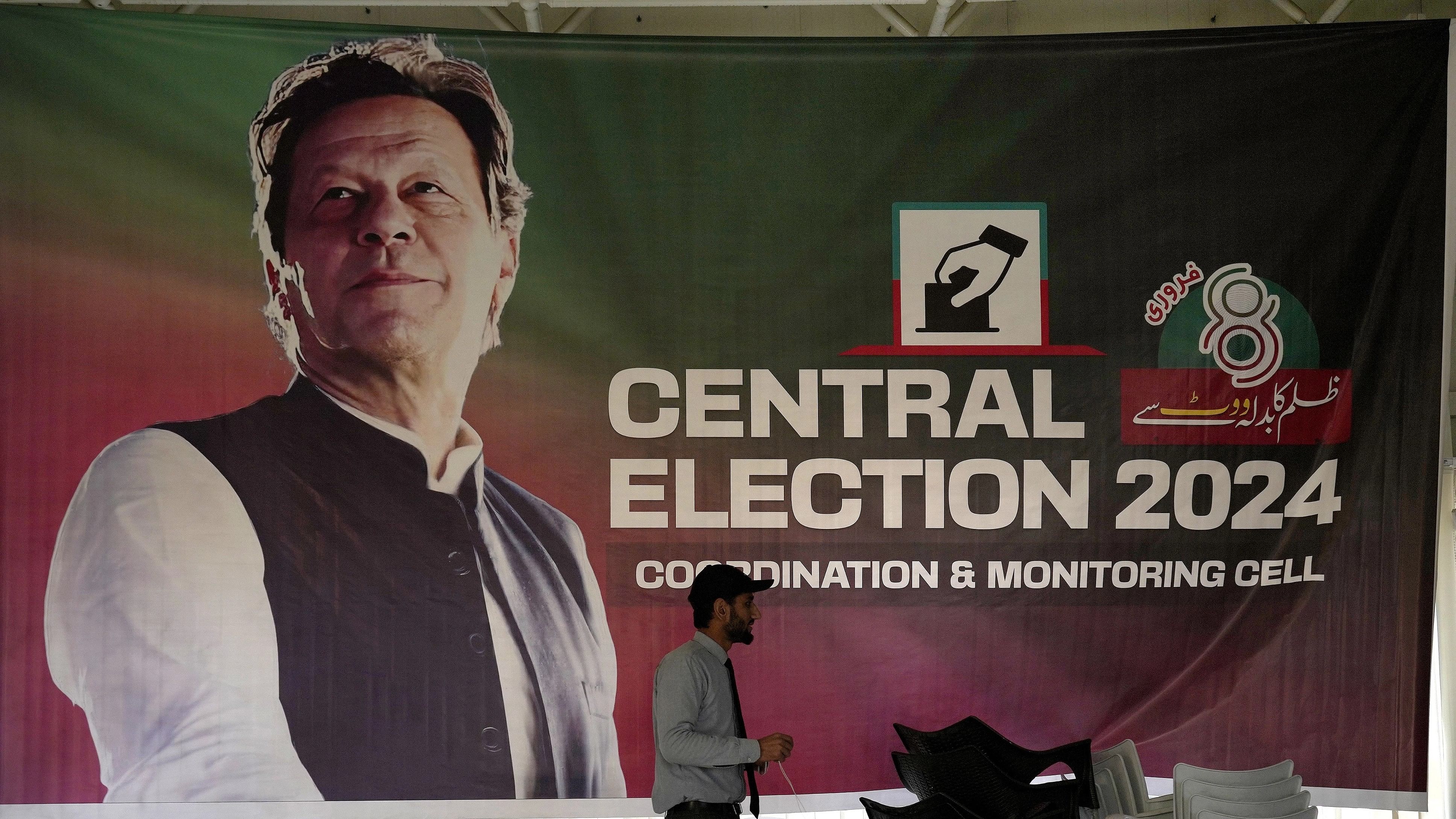 <div class="paragraphs"><p>A supporter walks past a poster of imprisoned leader Pakistan's Former Prime Minister Imran Khan display at his party office, in Islamabad, Pakistan.</p></div>