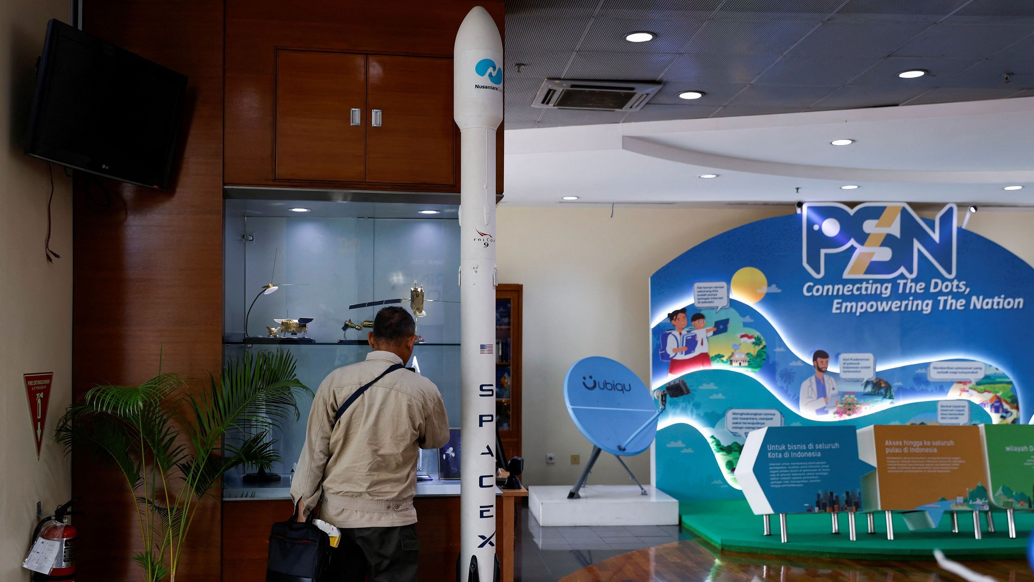 <div class="paragraphs"><p>A man stands next to a model of SpaceX’s Falcon 9 rocket, that launched the 4.1 tonne Nusantara Satu broadband satellite in February 2019, at the office of Pasifik Satelit Nusantara, an Indonesia’s satellite-based telecommunication firm, in Jakarta, Indonesia.</p></div>