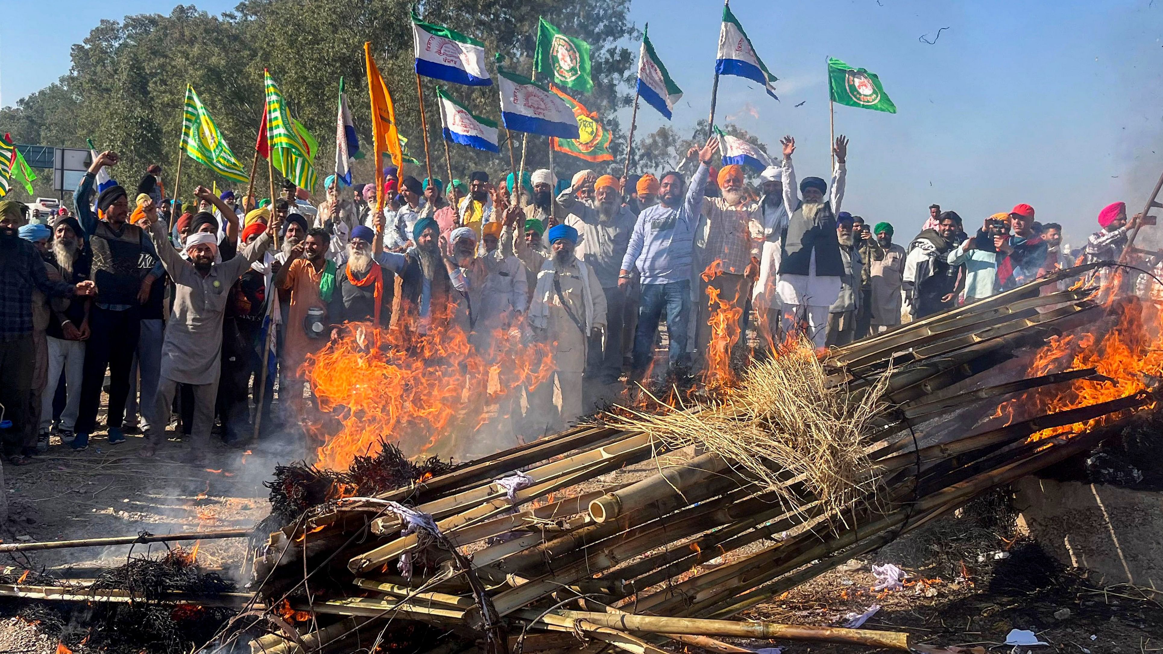 <div class="paragraphs"><p>Farmers holding flags shout slogans against corporate houses during a protest as part of their 'Delhi Chalo' march, near the Punjab-Haryana Shambhu border, in Patiala.</p></div>