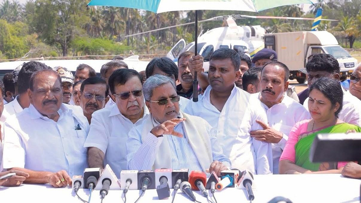 <div class="paragraphs"><p>Chief Minister Siddaramaiah interacts with media persons at the helipad of Banavara in Arasikere taluk of Hassan district on Saturday.</p></div>