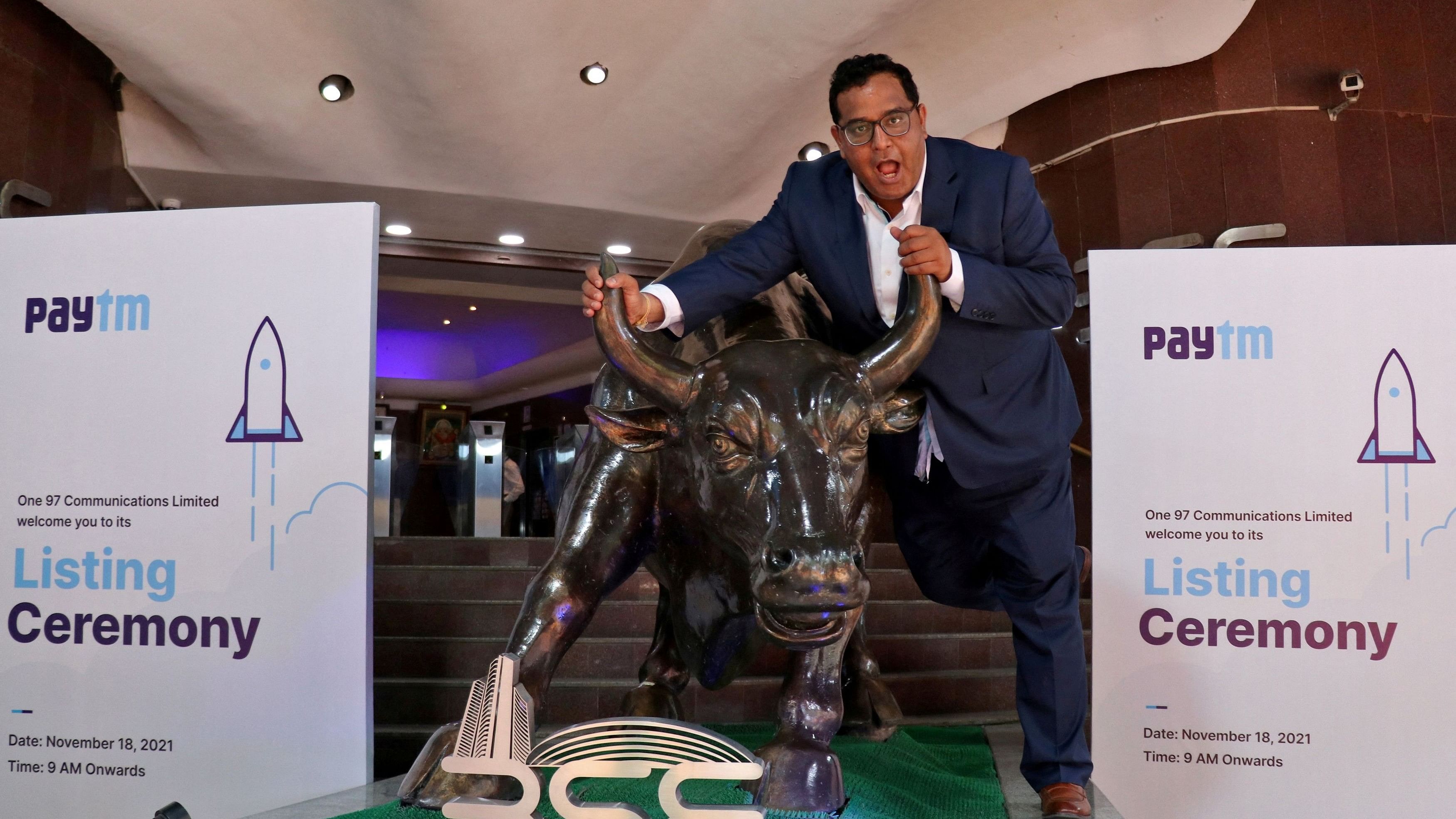<div class="paragraphs"><p>FILE PHOTO: Paytm founder and CEO Vijay Shekhar Sharma poses with a bronze replica of a bull after the company's IPO listing ceremony at the Bombay Stock Exchange  in Mumbai, India, November 18, 2021. </p></div>