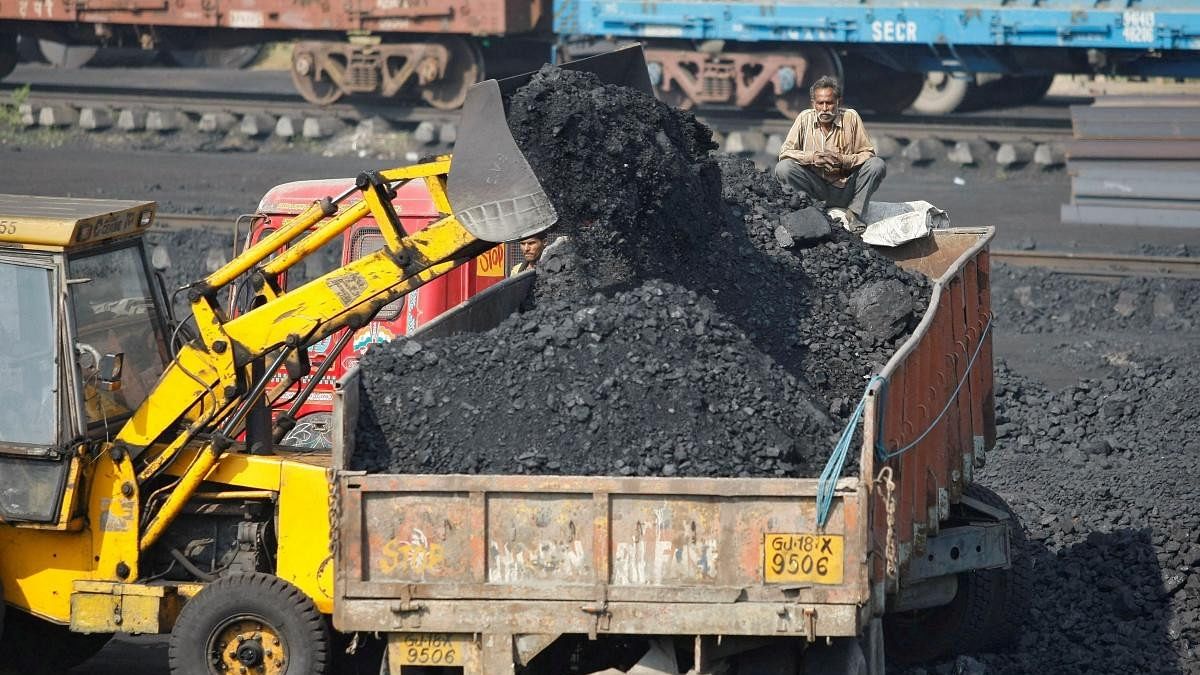 <div class="paragraphs"><p><strong>Truck being loaded with coal at a railway coal yard</strong></p></div>
