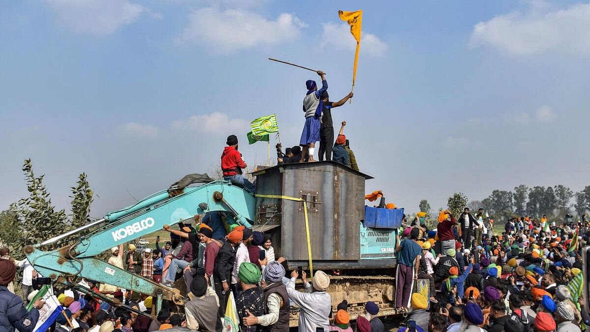 <div class="paragraphs"><p>Farmers near an excavator modified to shield from police rubber bullets, during their protest over various demands, including a legal guarantee on the minimum support price (MSP) for crops and farm loan waiver, at the Punjab-Haryana Shambhu Border, in Patiala</p></div>