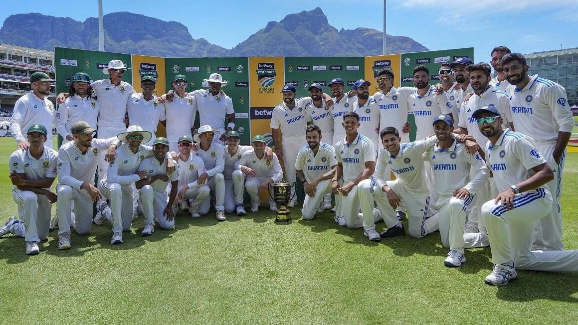 <div class="paragraphs"><p>Indian and South African players pose with the trophy at the end of the 2-match Test cricket series, known as The Freedom Series, between India and South Africa</p></div>